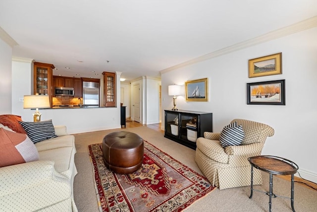 living room featuring sink, ornamental molding, and light carpet