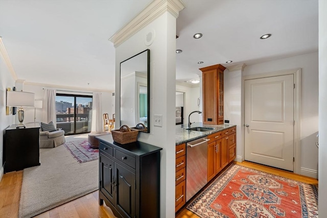 kitchen featuring crown molding, stainless steel dishwasher, light hardwood / wood-style flooring, sink, and light stone countertops