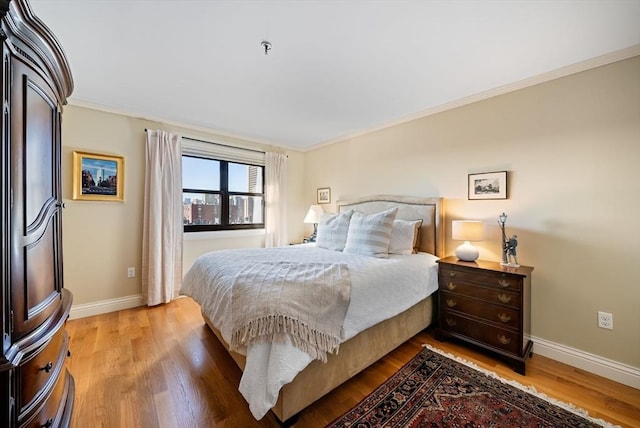 bedroom with light hardwood / wood-style floors and ornamental molding