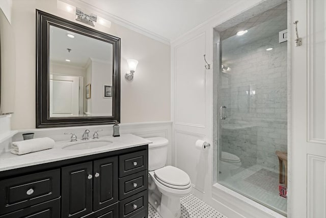 bathroom featuring a shower with shower door, toilet, vanity, and ornamental molding