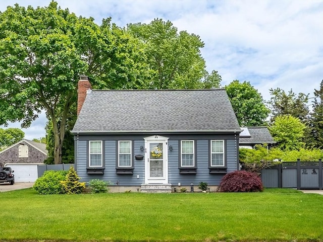 98 Moss St, New Bedford, MA 02744 - cape cod house with a chimney, a detached garage, and roof with shingles