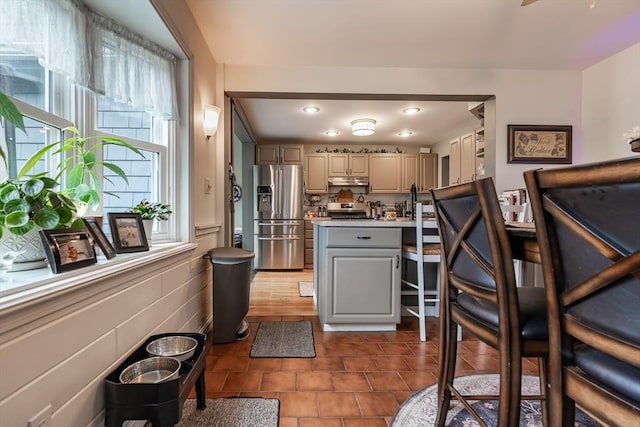 98 Moss St, New Bedford, MA 02744 - kitchen featuring stainless steel fridge with ice dispenser, gray cabinets, plenty of natural light, under cabinet range hood, and recessed lighting
