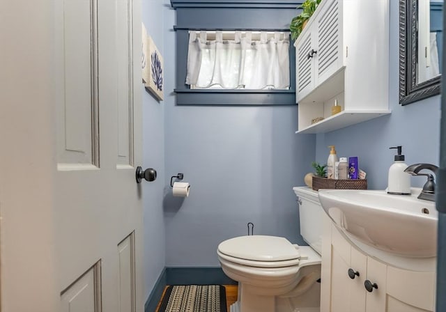 98 Moss St, New Bedford, MA 02744 - bathroom with vanity, toilet, and baseboards