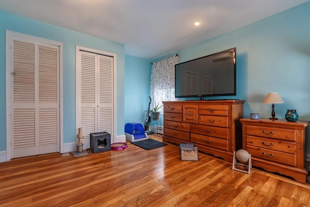 98 Moss St, New Bedford, MA 02744 - bedroom featuring multiple closets, wood finished floors, and baseboards