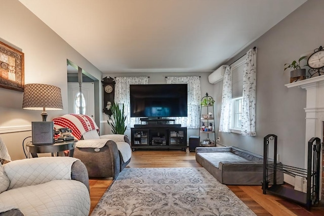 98 Moss St, New Bedford, MA 02744 - living area with wood finished floors and an AC wall unit