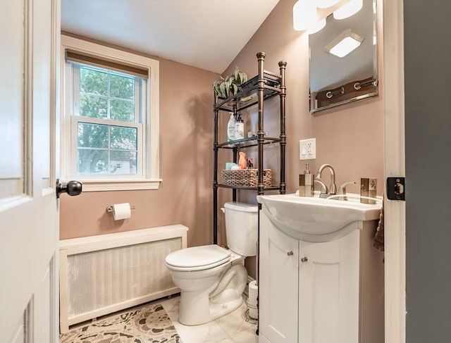 98 Moss St, New Bedford, MA 02744 - half bath featuring toilet, vanity, and radiator heating unit