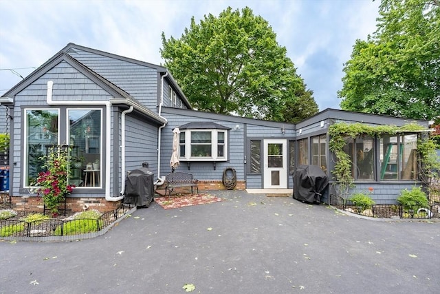 98 Moss St, New Bedford, MA 02744 - back of house featuring a sunroom and a patio