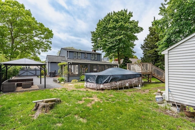 98 Moss St, New Bedford, MA 02744 - rear view of house featuring a gazebo, a lawn, stairway, a patio area, and a sunroom