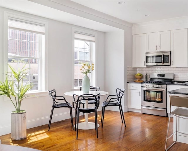 14 S Waverly St Unit 14, Boston, MA 02135 - kitchen featuring appliances with stainless steel finishes, dark countertops, healthy amount of natural light, and decorative backsplash