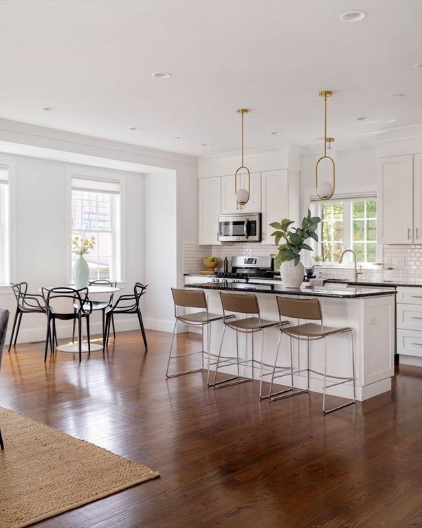 14 S Waverly St Unit 14, Boston, MA 02135 - kitchen with stainless steel appliances, backsplash, white cabinetry, and recessed lighting