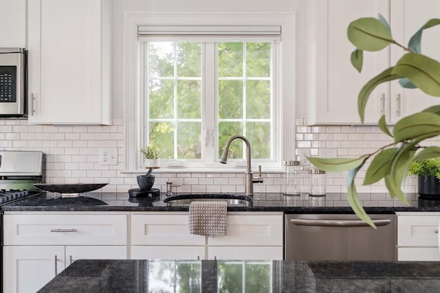 14 S Waverly St Unit 14, Boston, MA 02135 - kitchen with appliances with stainless steel finishes, a sink, white cabinetry, and dark stone counters