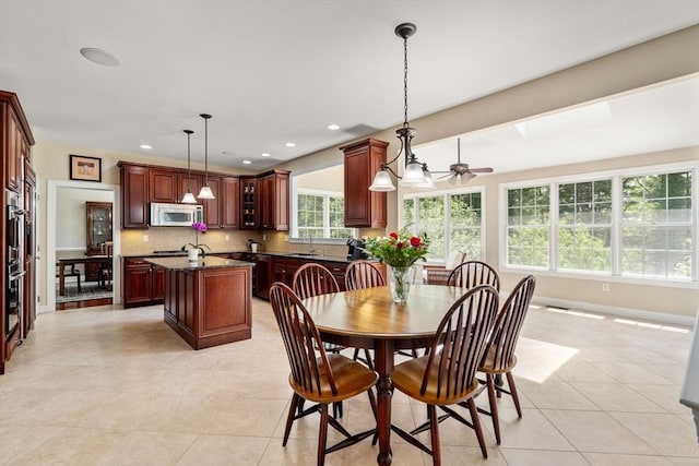 dining room featuring baseboards, light tile patterned floors, ceiling fan, and recessed lighting