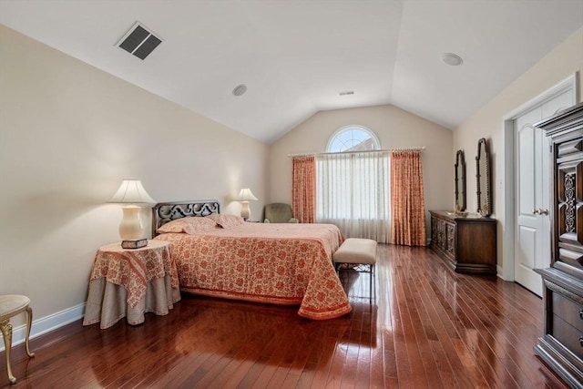 bedroom featuring hardwood / wood-style floors, vaulted ceiling, and baseboards