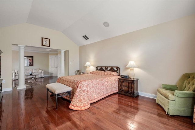 bedroom with ornate columns, hardwood / wood-style flooring, lofted ceiling, and baseboards