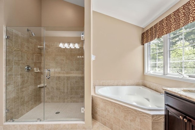 full bathroom featuring a garden tub, a stall shower, and vanity