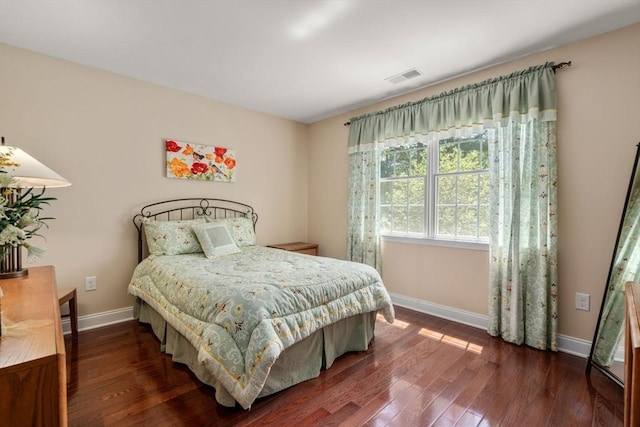bedroom featuring baseboards and dark wood-style floors