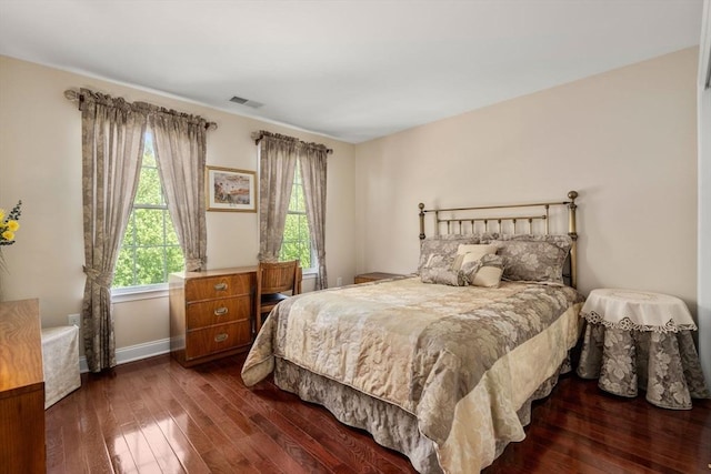 bedroom featuring hardwood / wood-style floors and baseboards