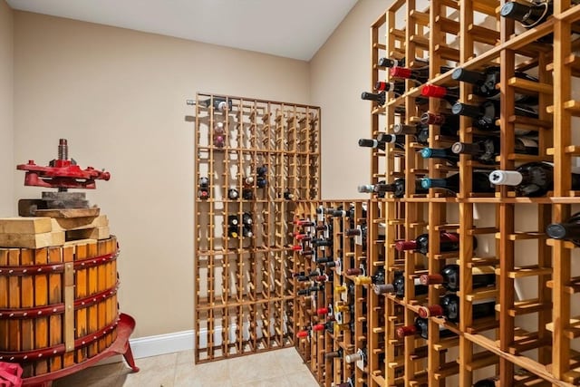 wine room with baseboards and tile patterned floors