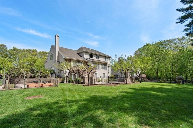 rear view of property featuring a garden and a chimney