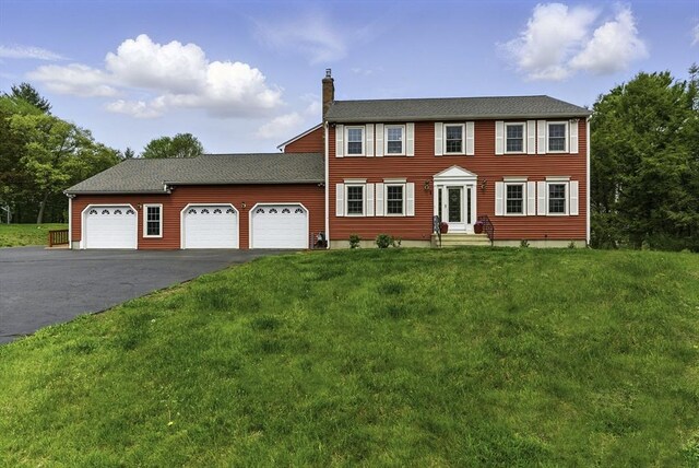 1 New Castle Rd, Ashland, MA 01721 - colonial-style house featuring a garage, a chimney, a front yard, asphalt driveway, and entry steps