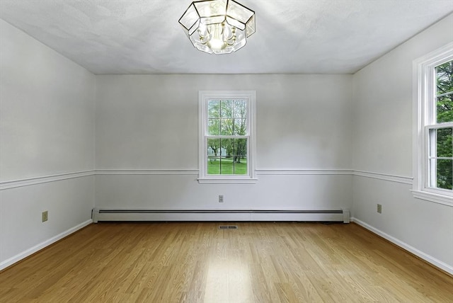 1 New Castle Rd, Ashland, MA 01721 - unfurnished room featuring light wood-style floors, a chandelier, and plenty of natural light