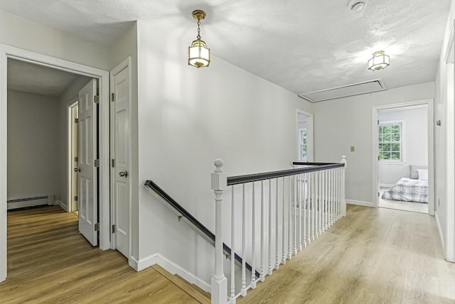 1 New Castle Rd, Ashland, MA 01721 - corridor featuring attic access, baseboard heating, an upstairs landing, and wood finished floors