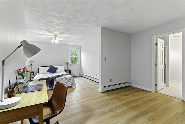 1 New Castle Rd, Ashland, MA 01721 - bedroom with baseboard heating, light wood-type flooring, baseboards, and a textured ceiling