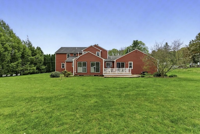 1 New Castle Rd, Ashland, MA 01721 - back of property featuring a wooden deck and a lawn