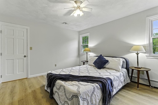 1 New Castle Rd, Ashland, MA 01721 - bedroom with wood finished floors, multiple windows, and a ceiling fan