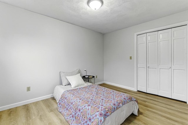 1 New Castle Rd, Ashland, MA 01721 - bedroom featuring wood finished floors, baseboards, a closet, and a textured ceiling
