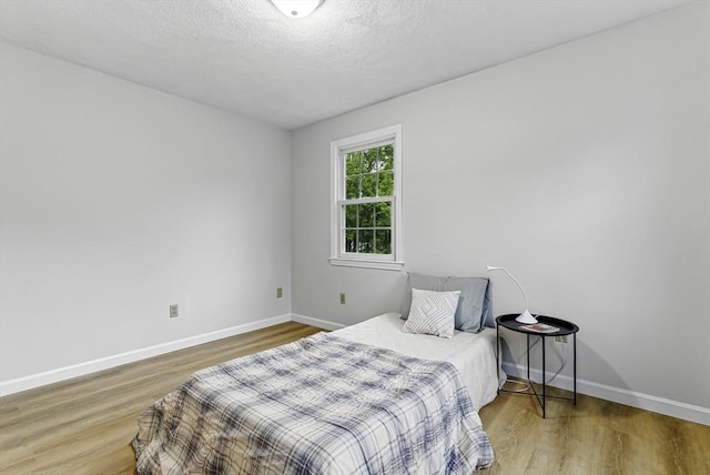 1 New Castle Rd, Ashland, MA 01721 - bedroom with wood finished floors, baseboards, and a textured ceiling