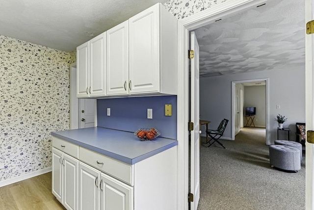 1 New Castle Rd, Ashland, MA 01721 - kitchen featuring white cabinets, baseboards, and wallpapered walls