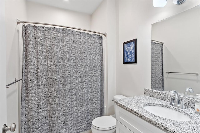 bathroom with vanity, walk in shower, and toilet