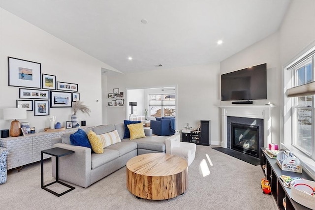 living room with lofted ceiling and light colored carpet