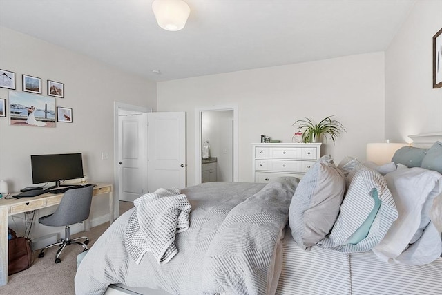 bedroom featuring ensuite bath and light colored carpet