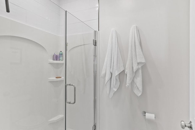 bathroom with a shower with door