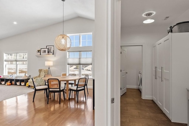 interior space with lofted ceiling, washer / clothes dryer, and hardwood / wood-style floors