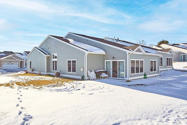 snow covered property featuring cooling unit