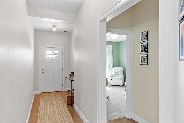 entryway with light colored carpet