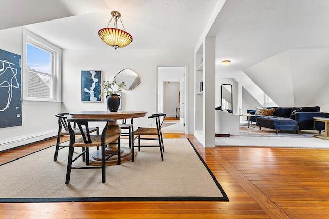 dining area featuring built in shelves and light hardwood / wood-style floors