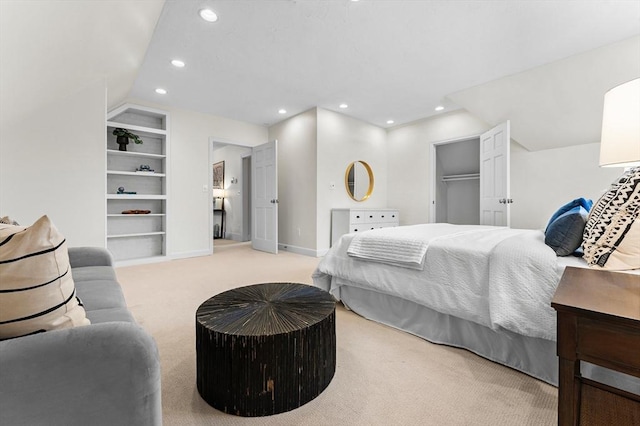 carpeted bedroom featuring lofted ceiling, a spacious closet, and a closet