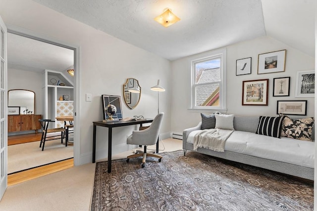 carpeted home office featuring a baseboard radiator, vaulted ceiling, and a textured ceiling