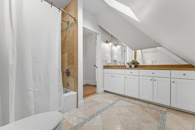 full bathroom featuring lofted ceiling with skylight, toilet, vanity, and shower / tub combo with curtain