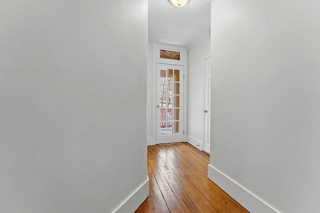 hallway with light hardwood / wood-style floors