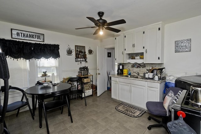 320 Oakland St, Springfield, MA 01108 - kitchen featuring a ceiling fan, white cabinets, light countertops, tasteful backsplash, and a sink