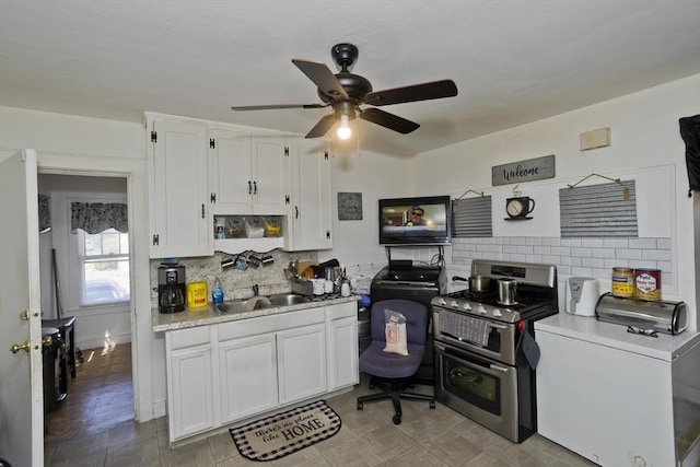 320 Oakland St, Springfield, MA 01108 - kitchen featuring range with two ovens, a ceiling fan, a sink, white cabinets, and tasteful backsplash