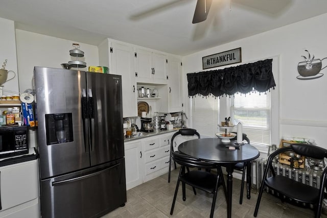 320 Oakland St, Springfield, MA 01108 - kitchen featuring stainless steel fridge, black microwave, white cabinets, and ceiling fan