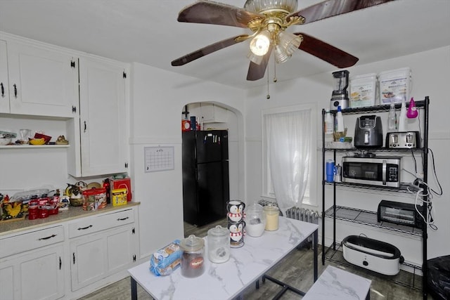 320 Oakland St, Springfield, MA 01108 - kitchen with freestanding refrigerator, stainless steel microwave, white cabinets, and ceiling fan