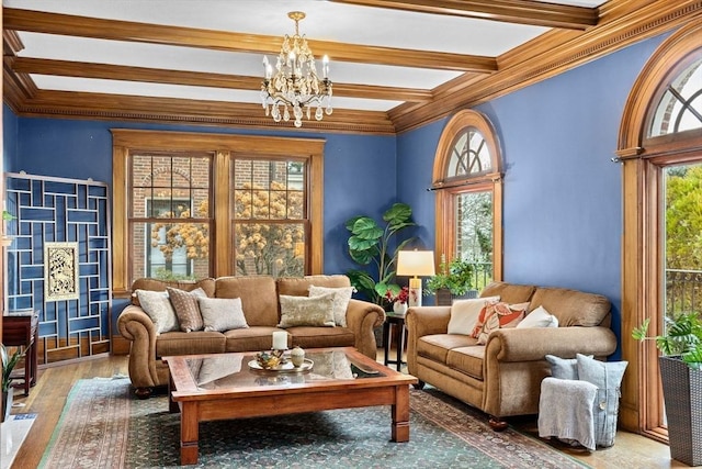 sitting room with ornamental molding, hardwood / wood-style flooring, a notable chandelier, and beam ceiling