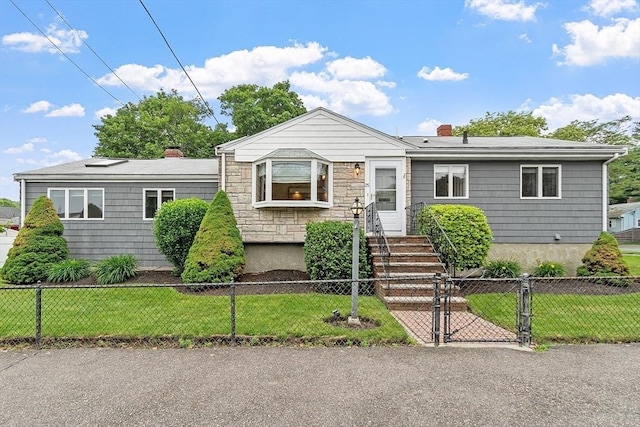 25 Ocallaghan Way, Lynn, MA 01905 - view of front facade featuring a fenced front yard, a chimney, a gate, and stone siding
